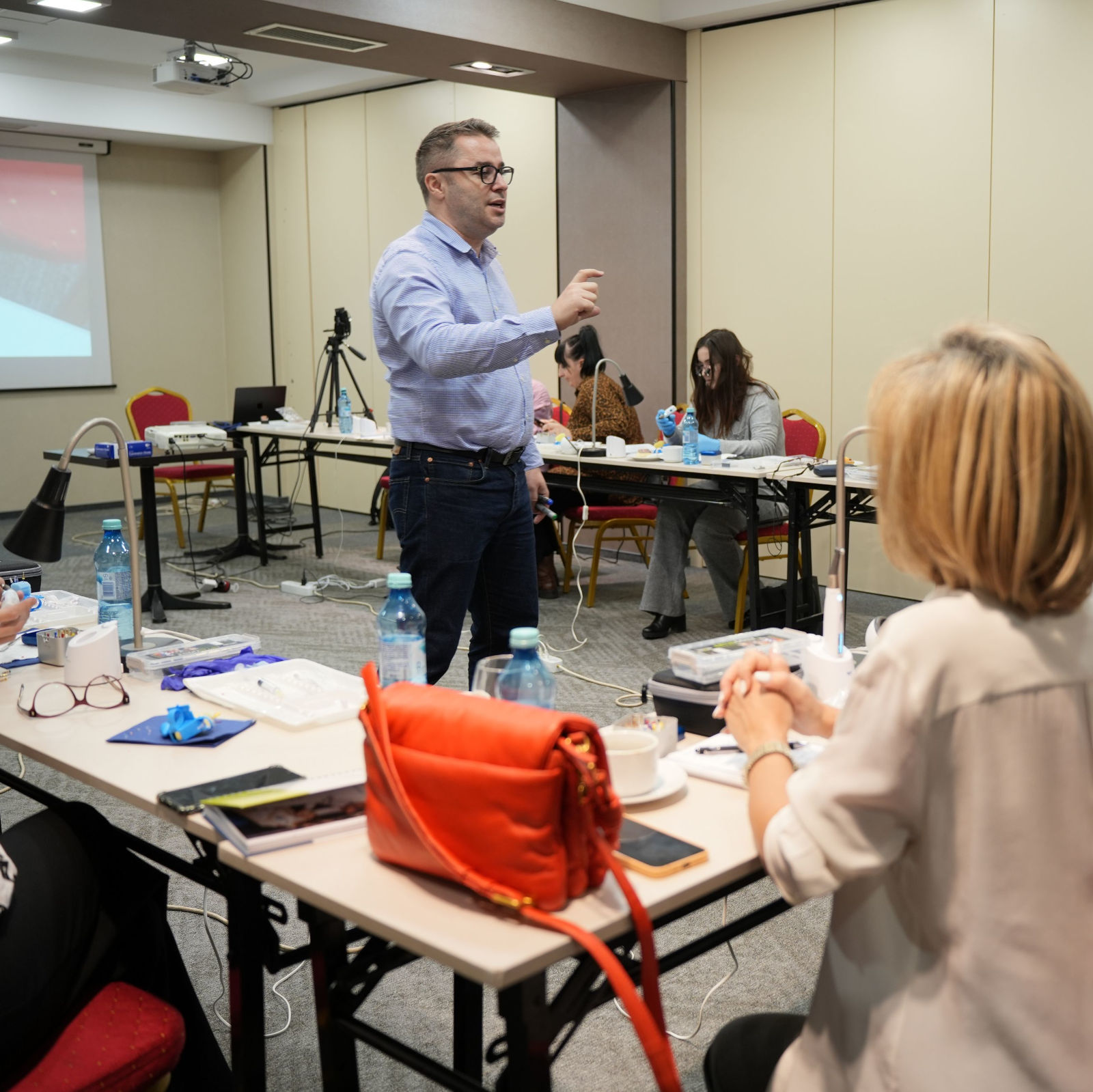 Dentist teaching workshop with medical professionals